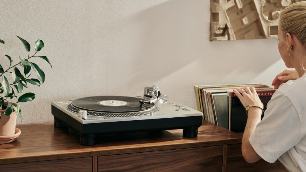 Technics SL-1200 Turntable being used by a blonde woman